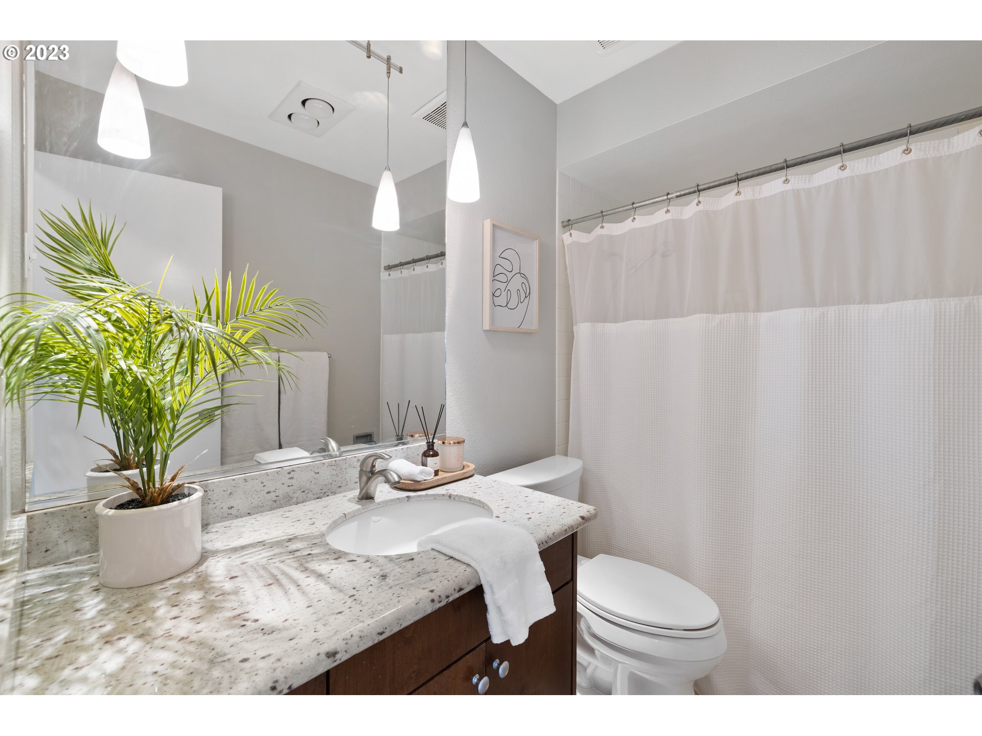 2038 Northeast Clackamas Street Portland, OR 97232 - Photo 25 of 32 a bathroom with a sink a toilet and a mirror