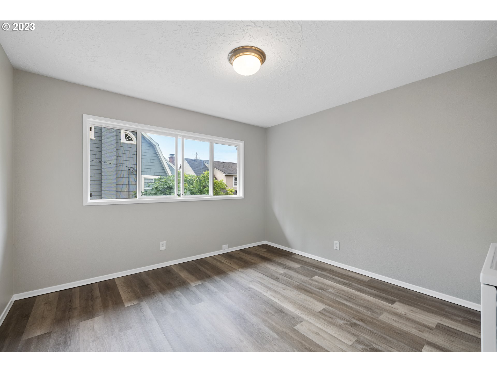 2038 Northeast Clackamas Street Portland, OR 97232 - Photo 26 of 32 a view of an empty room with wooden floor and a window