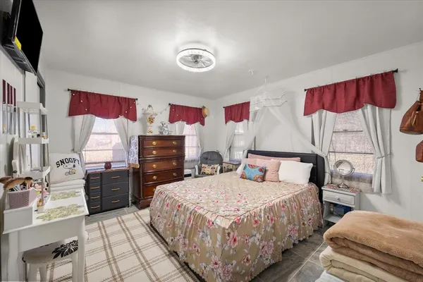a bedroom with two beds and a chandelier