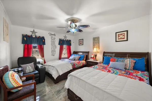 a bathroom with a granite countertop sink mirror vanity and toilet