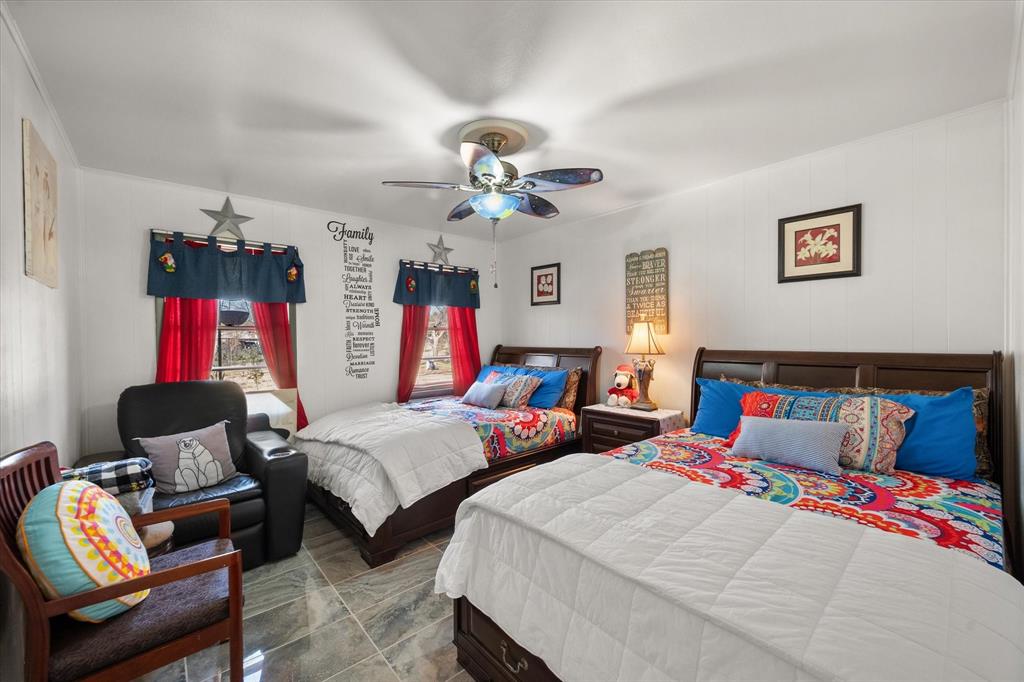 448 South Bateman Road Fairfield, TX 75840 - Photo 12 of 24 a bedroom with two beds and a chandelier