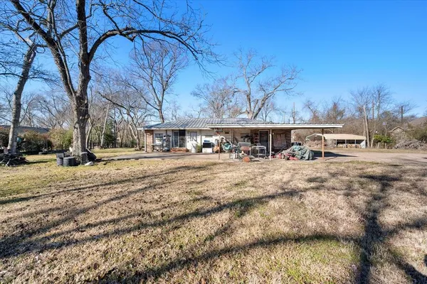 a view of a yard with wooden fence