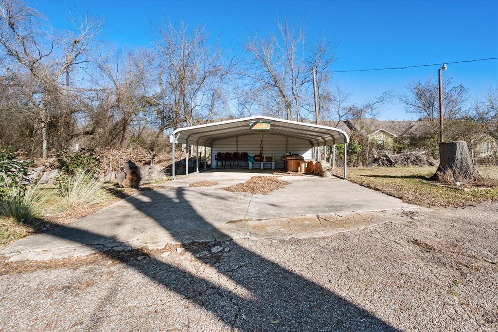 448 South Bateman Road Fairfield, TX 75840 - Photo 20 of 24 a view of a yard with a table and chairs under an umbrella