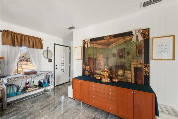 a kitchen with stainless steel appliances and wooden floor