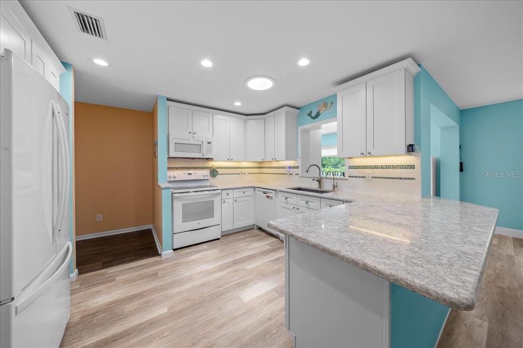8720 Southwest 90th Street, Unit A Ocala, FL 34481 - Photo 26 of 71 a kitchen with stainless steel appliances granite countertop a sink stove and refrigerator