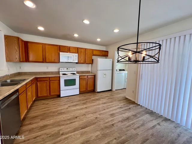 a kitchen with stainless steel appliances granite countertop a stove sink and cabinets