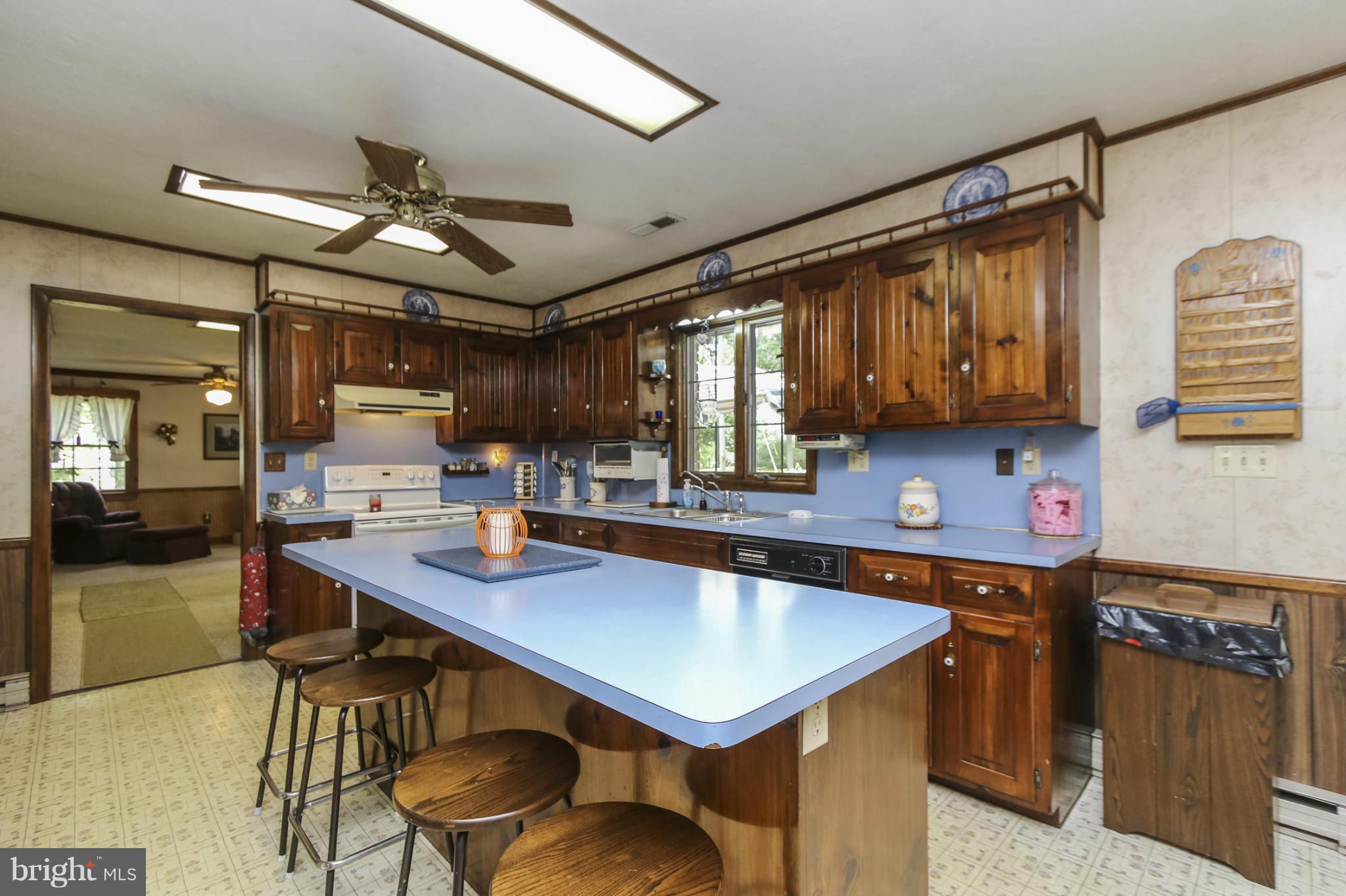 4355 Ruggles Road Taneytown, MD 21787 - Photo 2 of 27 a kitchen with a table chairs microwave and cabinets