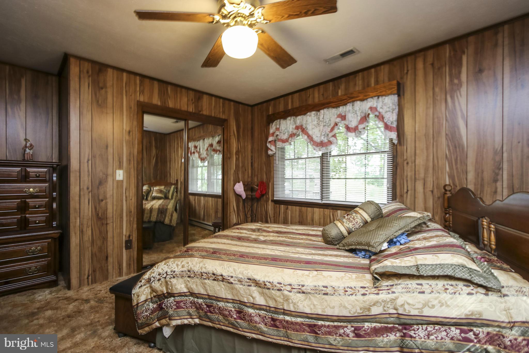 4355 Ruggles Road Taneytown, MD 21787 - Photo 11 of 27 a bedroom with a bed and a chandelier