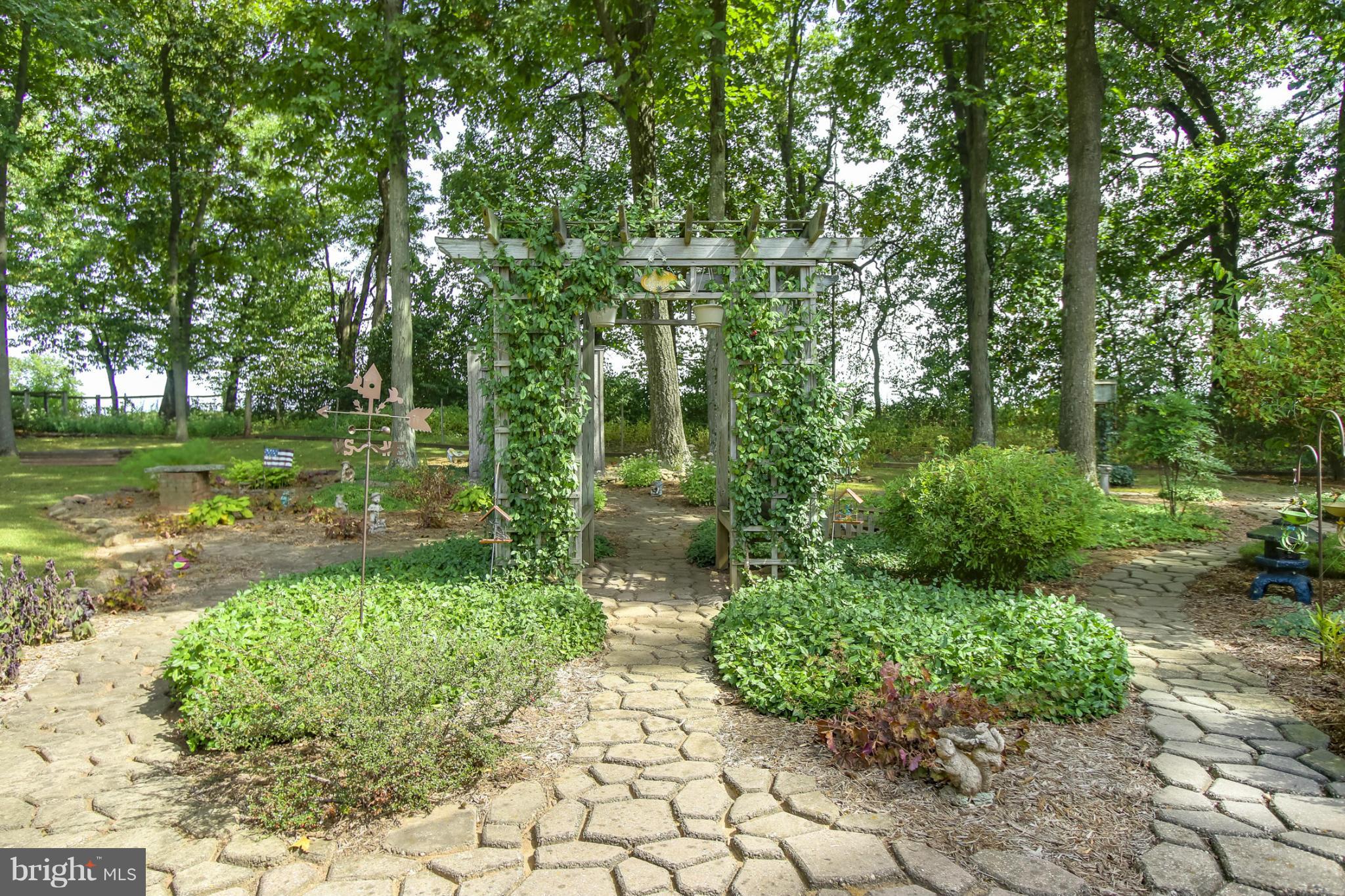 4355 Ruggles Road Taneytown, MD 21787 - Photo 19 of 27 a view of a garden with a bench