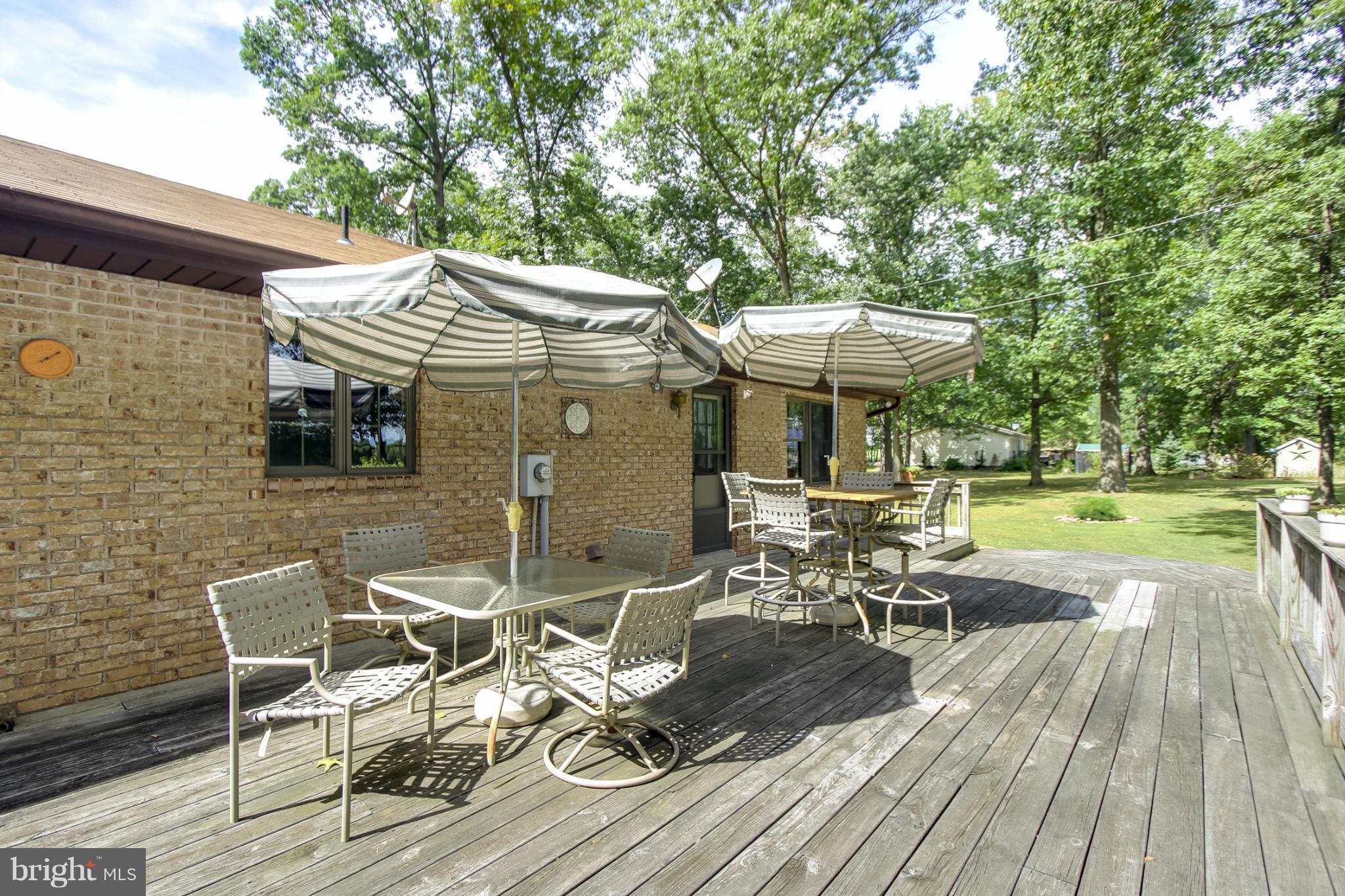 4355 Ruggles Road Taneytown, MD 21787 - Photo 20 of 27 a view of a patio with table and chairs with wooden floor and fence