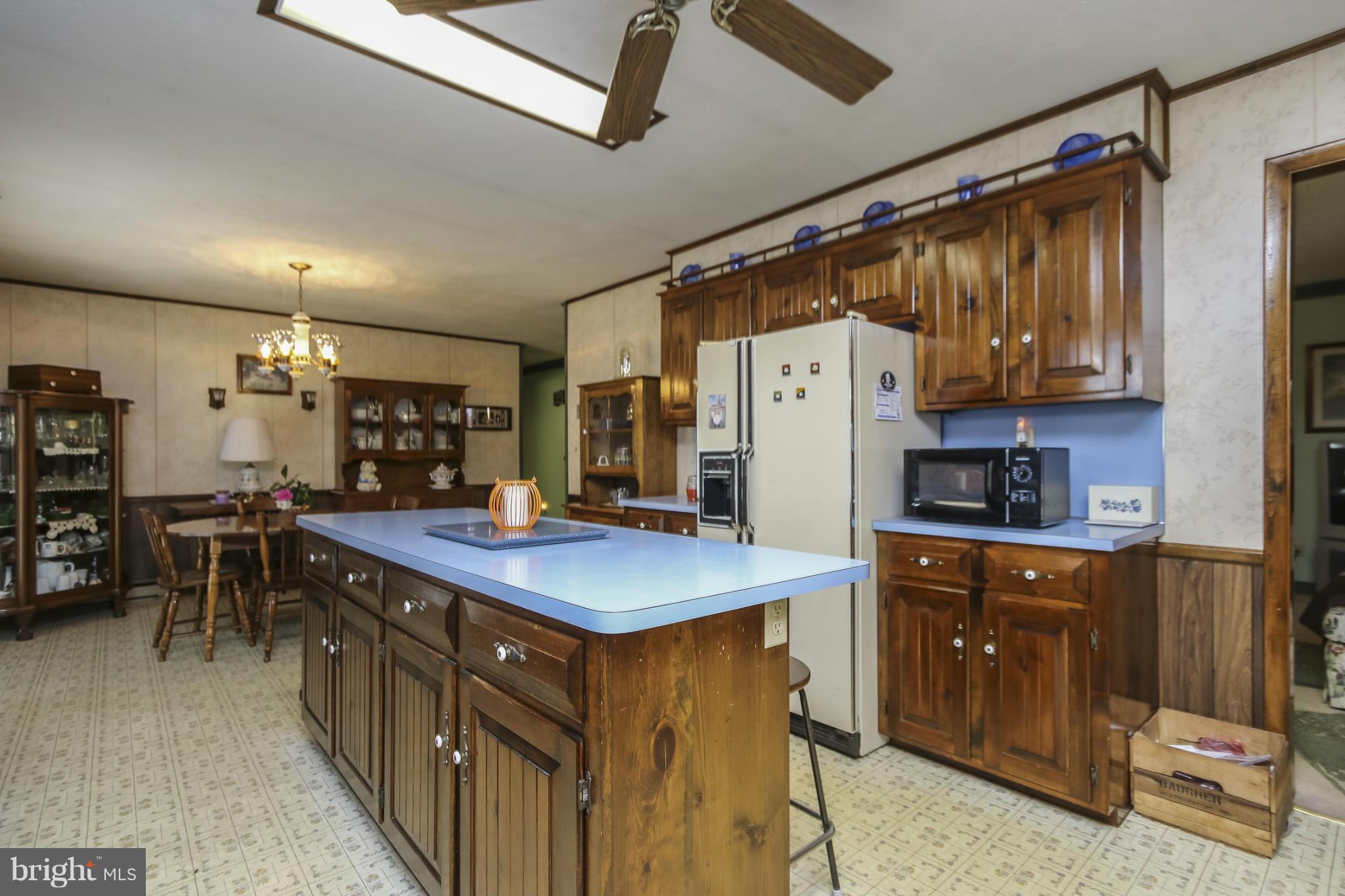 4355 Ruggles Road Taneytown, MD 21787 - Photo 4 of 27 a kitchen with stainless steel appliances granite countertop a sink a stove and a refrigerator