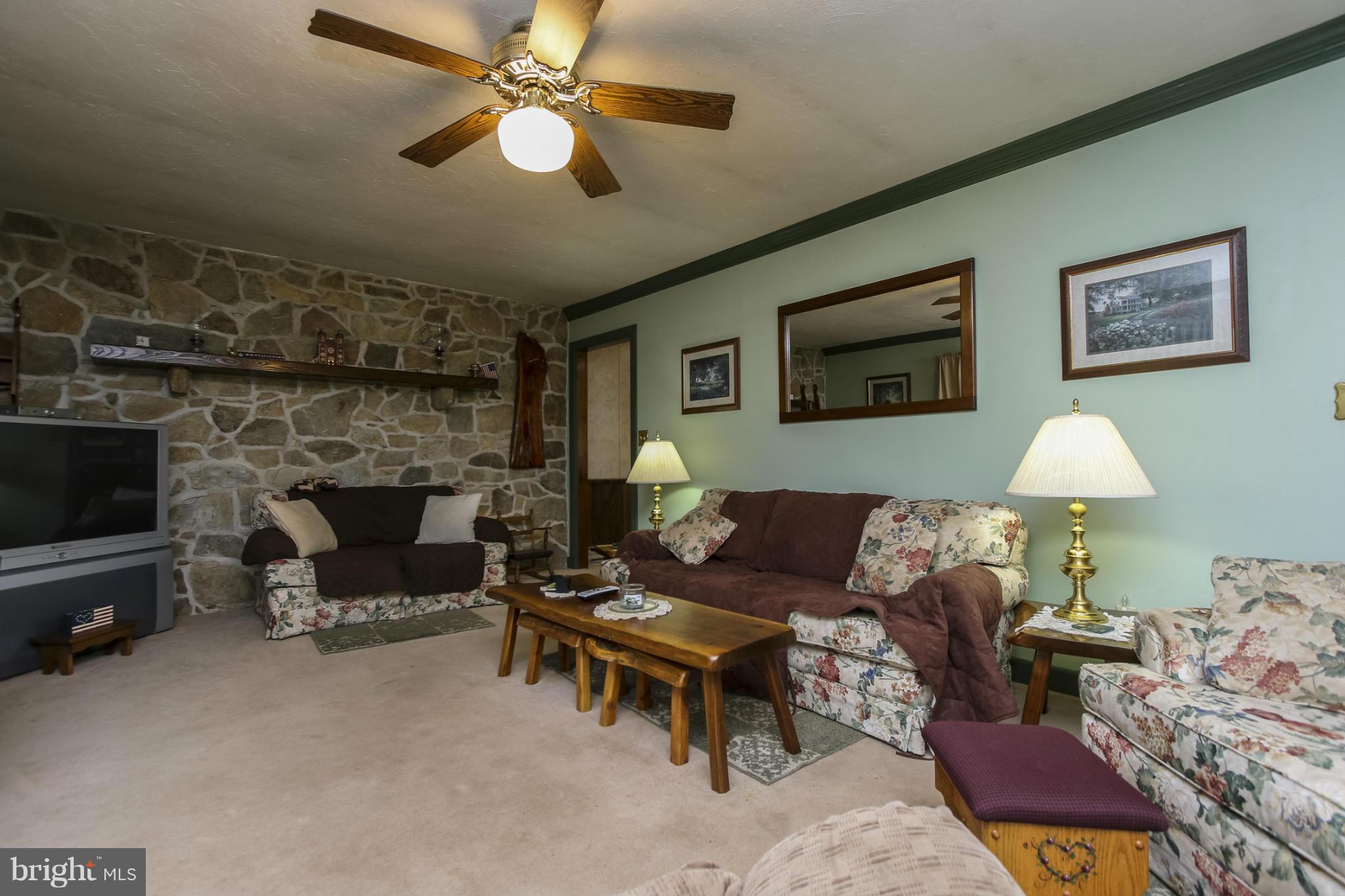 4355 Ruggles Road Taneytown, MD 21787 - Photo 6 of 27 a living room with furniture and a fireplace