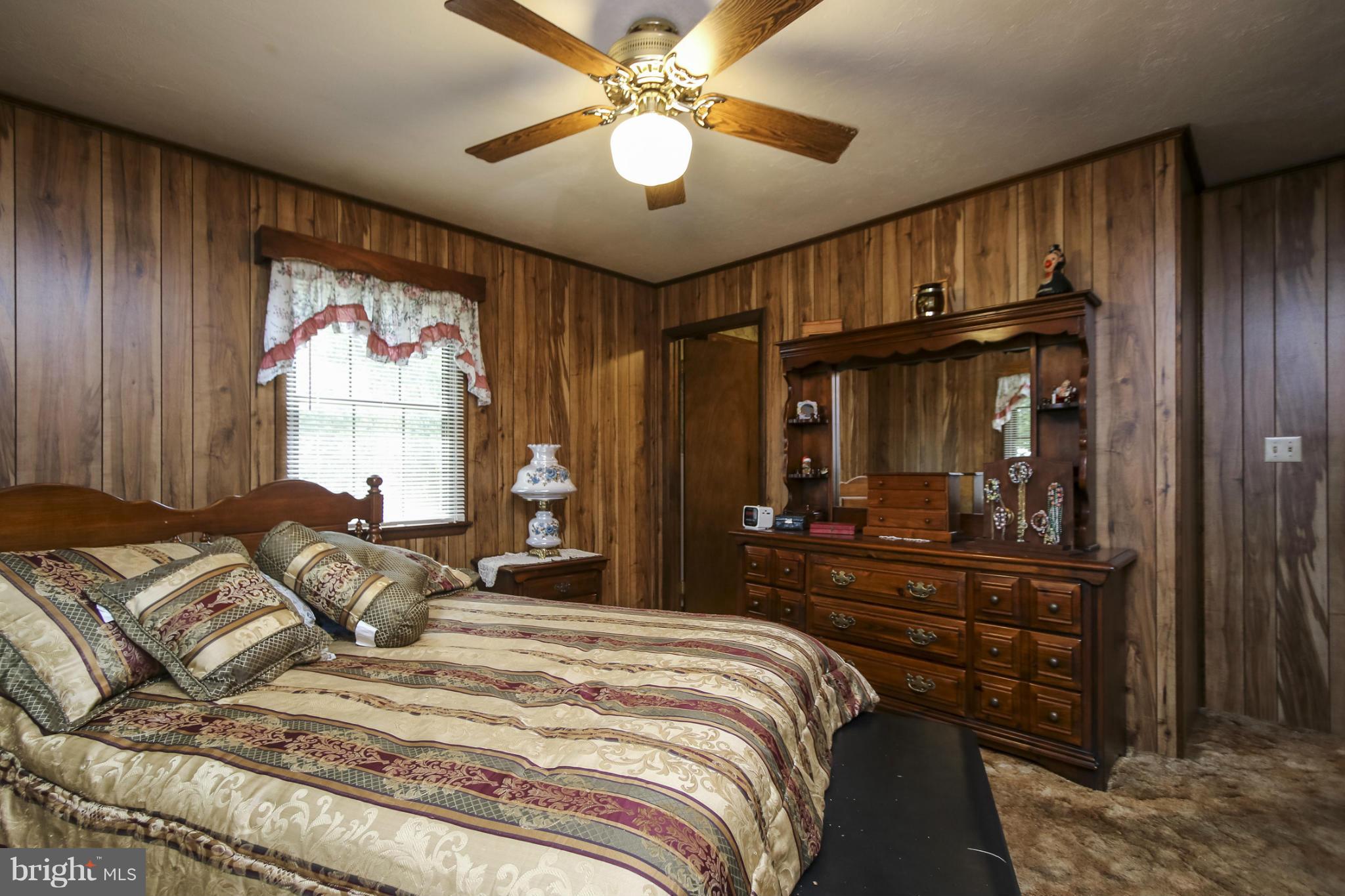 4355 Ruggles Road Taneytown, MD 21787 - Photo 10 of 27 a bedroom with a bed mirror and a window