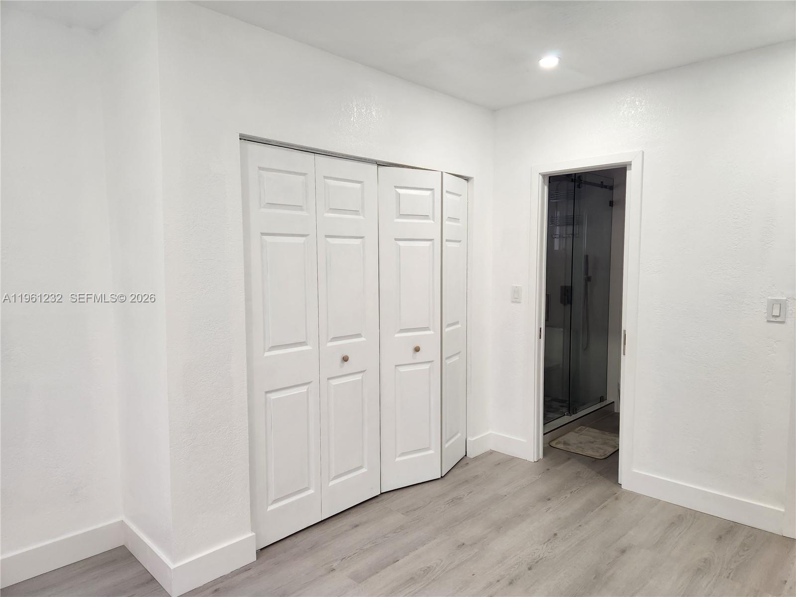 12460 Southwest 187th Terrace, Unit 1 Miami, FL 33177 - Photo 11 of 16 an empty room with wooden floor