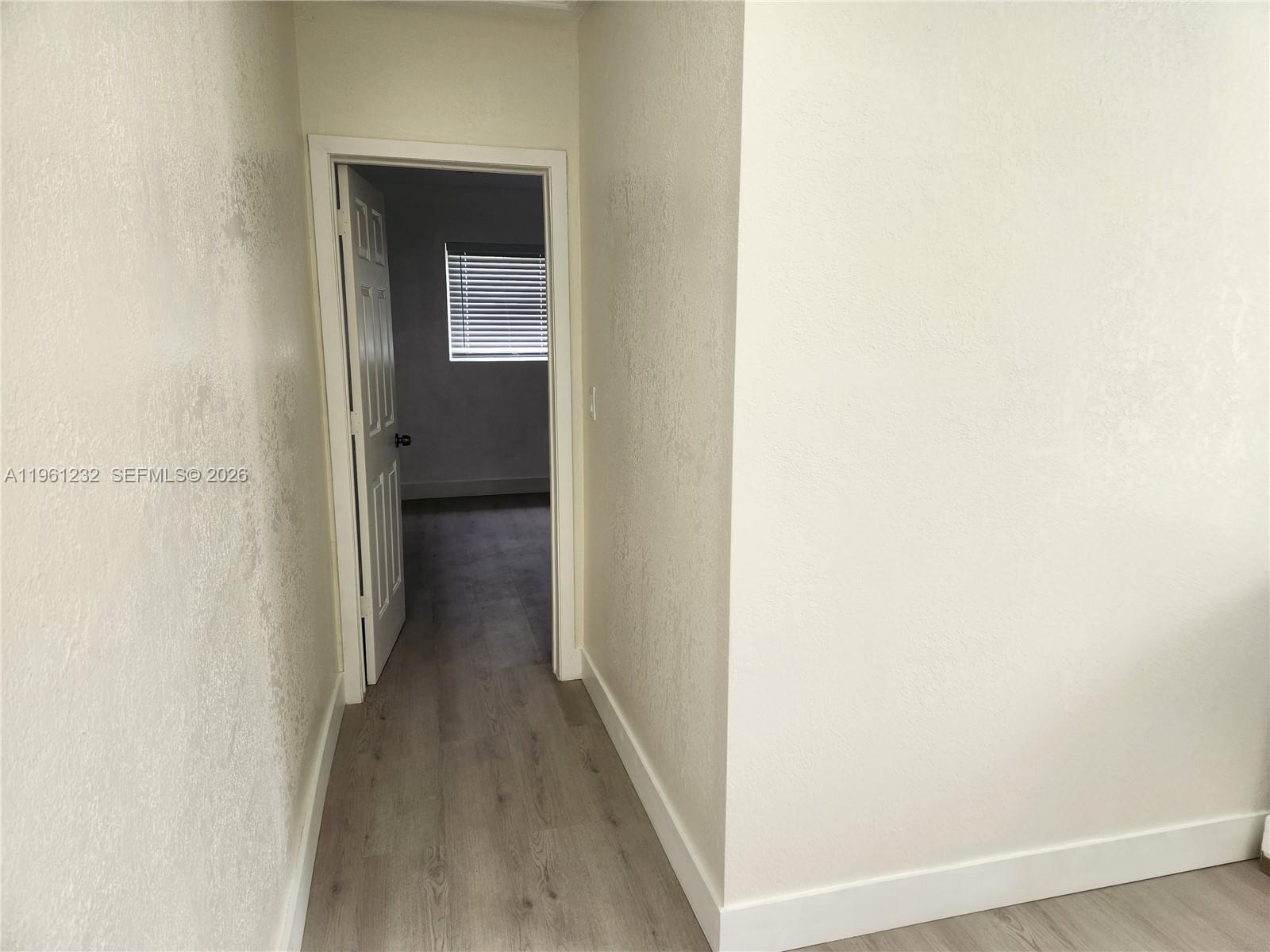 12460 Southwest 187th Terrace, Unit 1 Miami, FL 33177 - Photo 12 of 16 a view of a small space with wooden floor