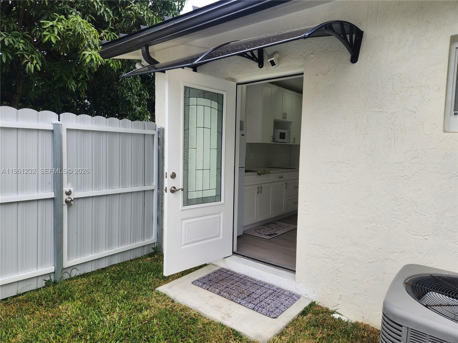 12460 Southwest 187th Terrace, Unit 1 Miami, FL 33177 - Photo 3 of 16 a view of an entryway door