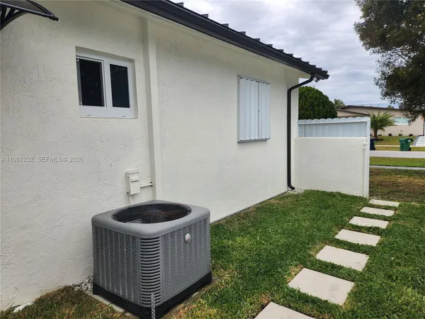 a kitchen with granite countertop a sink and a stove top oven