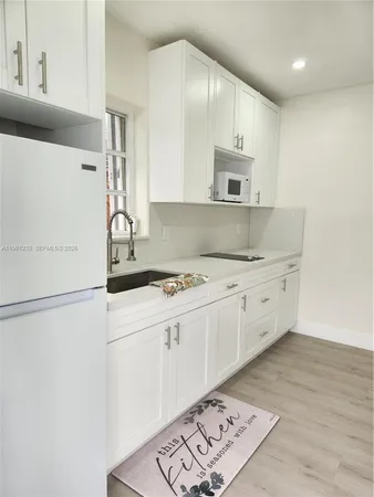 a view of a kitchen with washer and dryer
