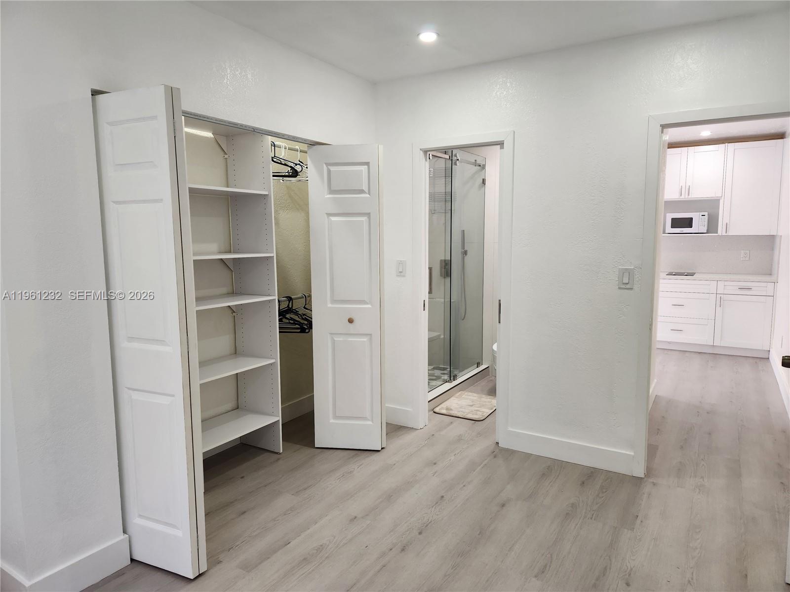 12460 Southwest 187th Terrace, Unit 1 Miami, FL 33177 - Photo 8 of 16 a view of empty room with wooden floor and window