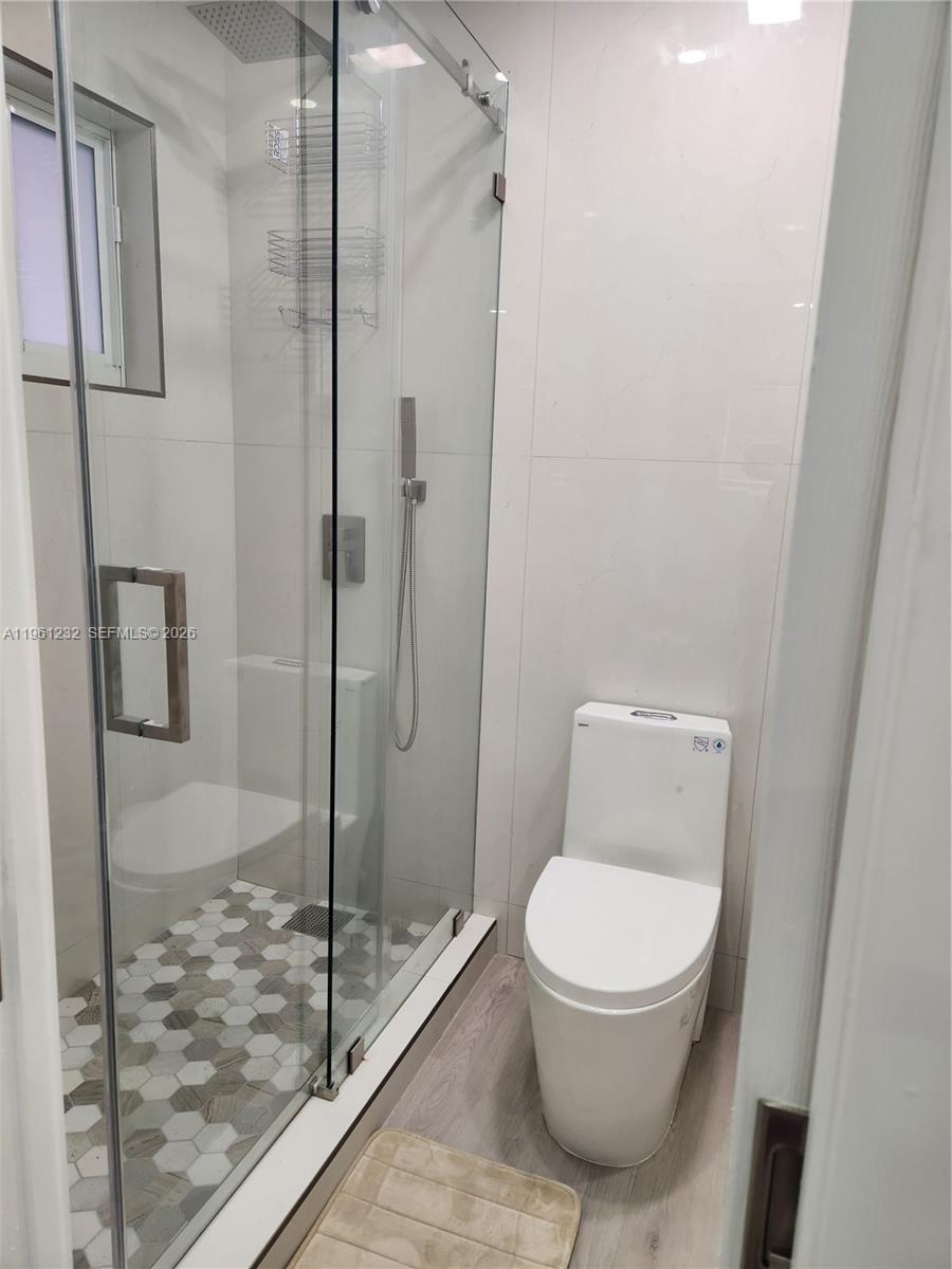 12460 Southwest 187th Terrace, Unit 1 Miami, FL 33177 - Photo 10 of 16 a bathroom with a toilet and a shower