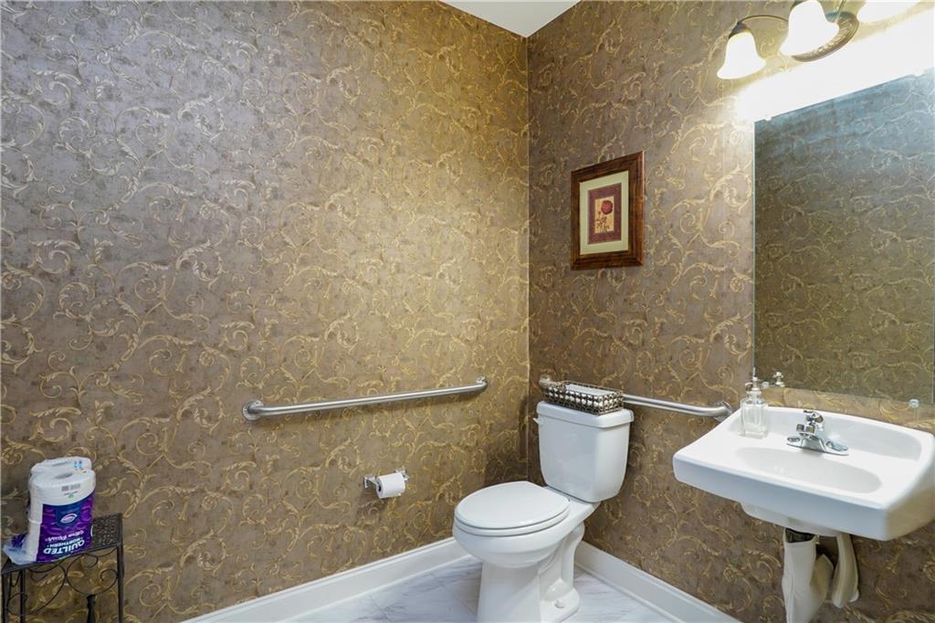 2775 Cruse Road Northwest, Unit 802 Lawrenceville, GA 30044 - Photo 14 of 16 a bathroom with a toilet a sink and mirror