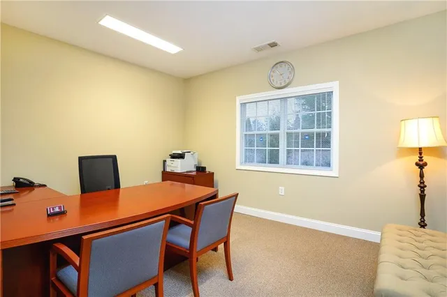 a view of a dining room with a table and chairs