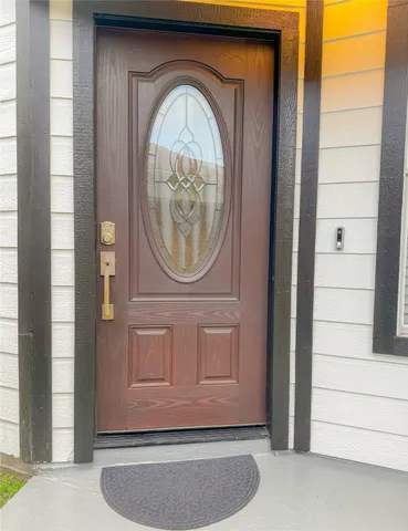 a view of a house with a wooden door and a wooden door