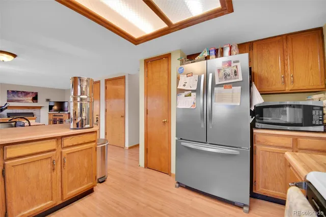 a kitchen with stainless steel appliances granite countertop a refrigerator and a stove top oven
