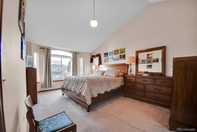 a spacious bedroom with a bed and window