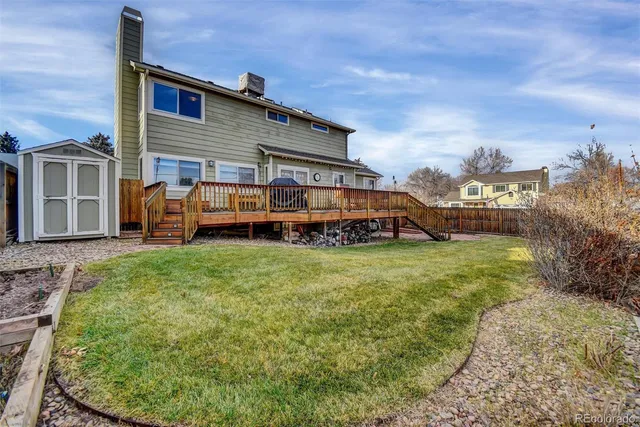 a balcony with wooden floor and outdoor seating