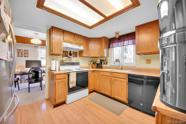 a kitchen with stainless steel appliances granite countertop a stove a sink dishwasher and a refrigerator
