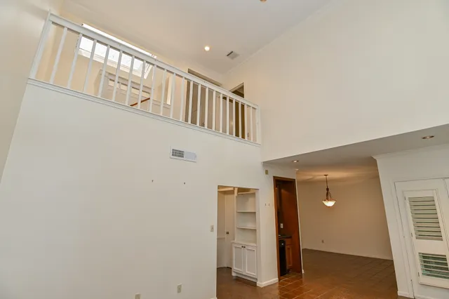 a view of an empty room with a fireplace and a window