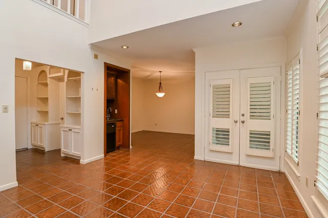 an empty room with a cabinet and mirrors