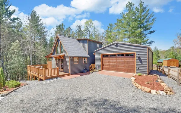 a view of a house with a yard and garage