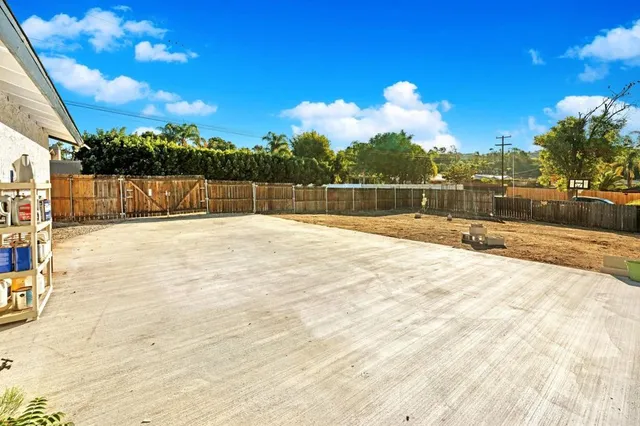 a backyard of a house with table and chairs