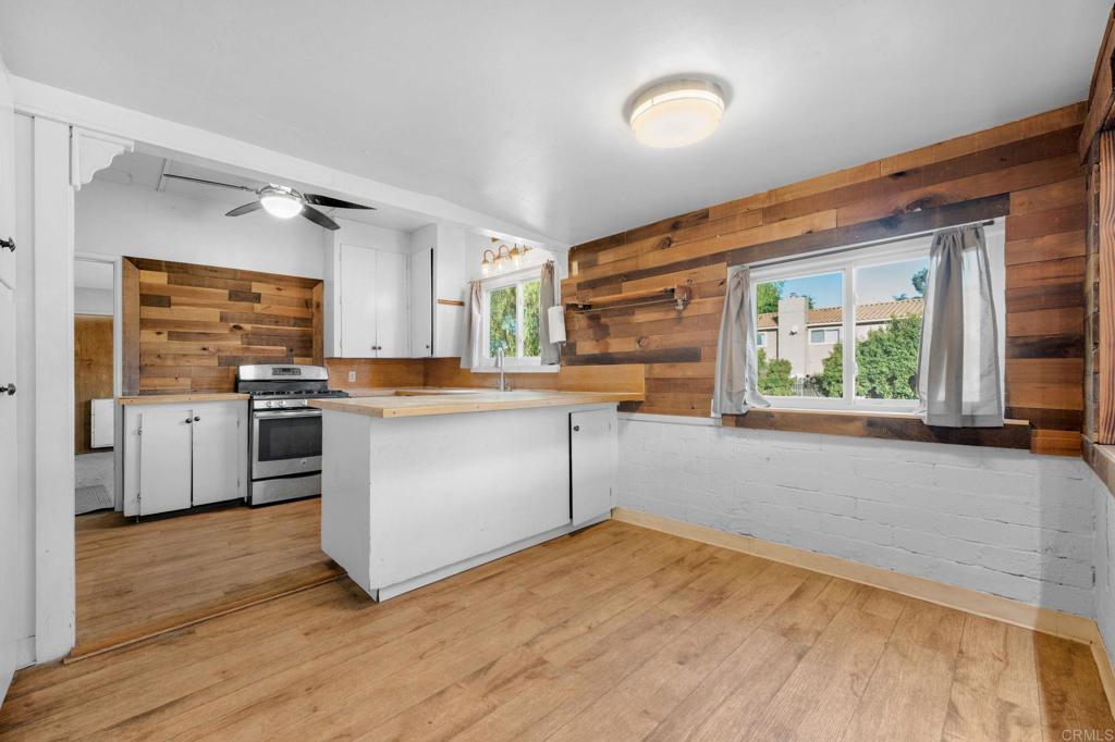 8273 Melrose Lane El Cajon, CA 92021 - Photo 8 of 33 a kitchen with stainless steel appliances granite countertop a stove a sink and a refrigerator