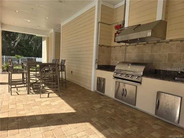 a kitchen with granite countertop a stove a table and chairs in it