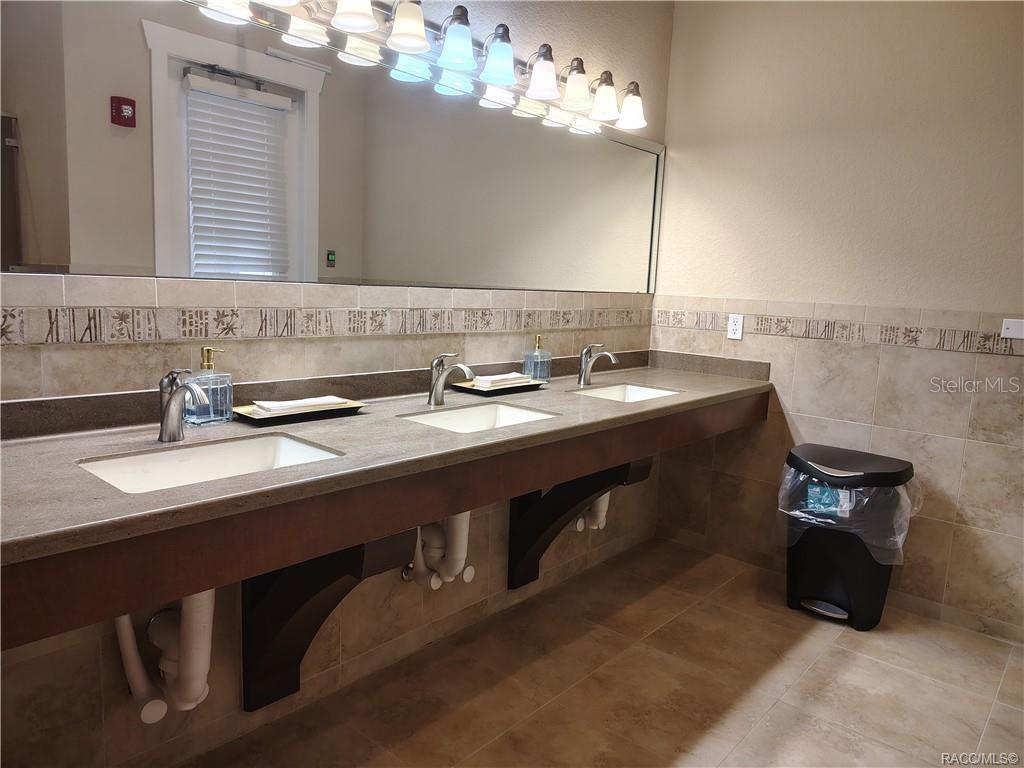 279 Bittern Loop Inverness, FL 34453 - Photo 30 of 30 a bathroom with a sink double vanity and a mirror