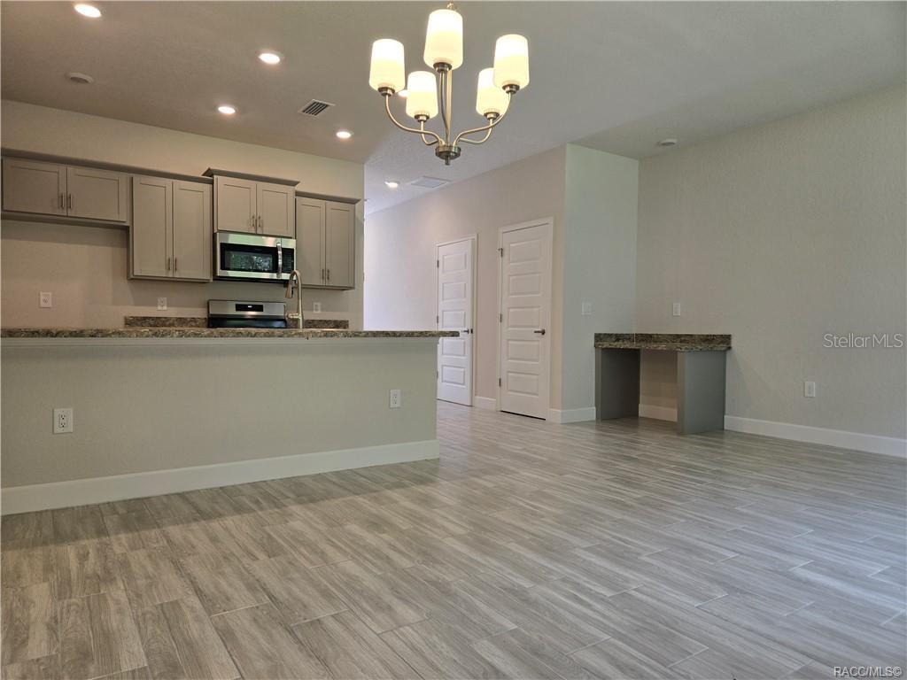 279 Bittern Loop Inverness, FL 34453 - Photo 7 of 30 a view of a kitchen with a sink and dishwasher a oven with wooden floor