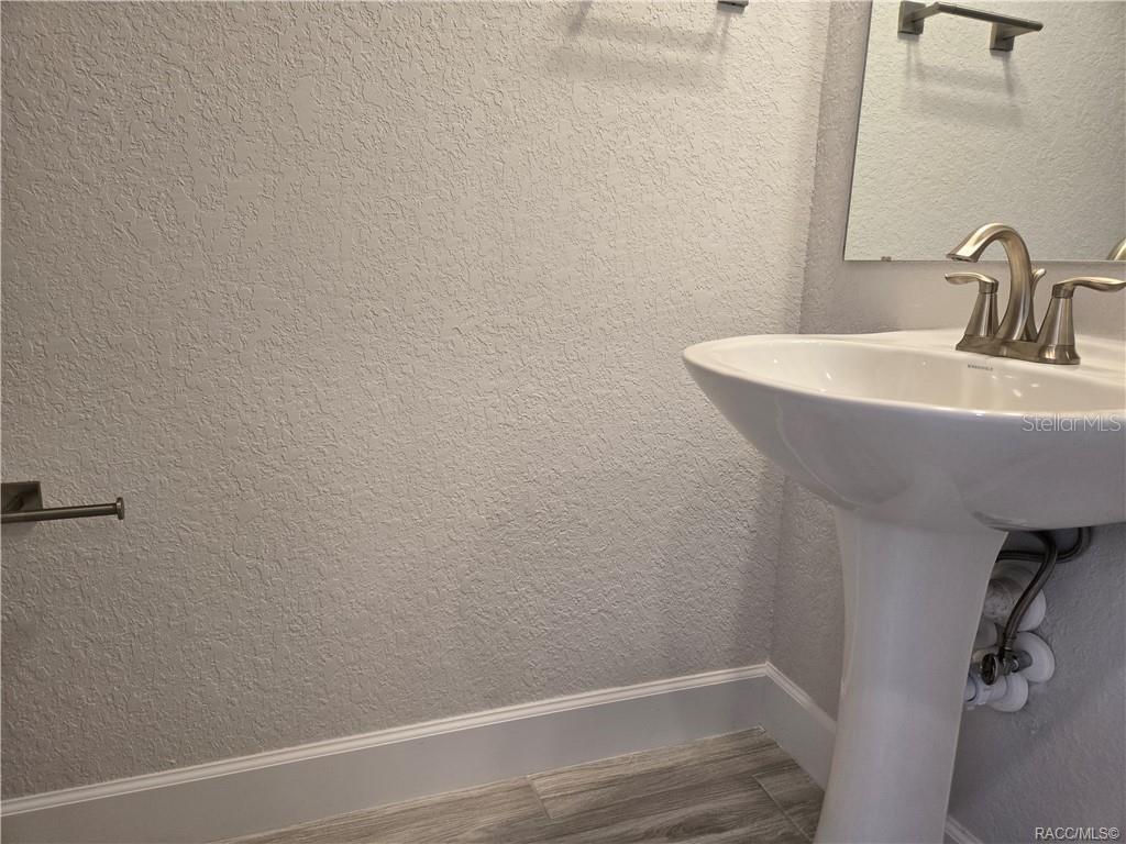 279 Bittern Loop Inverness, FL 34453 - Photo 8 of 30 a bathroom with a sink and a mirror