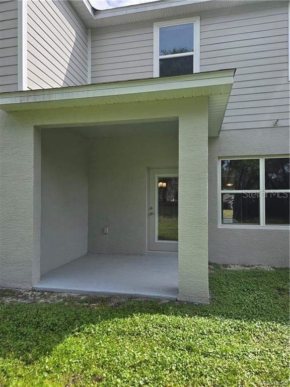 279 Bittern Loop Inverness, FL 34453 - Photo 9 of 30 a front view of a house with a yard