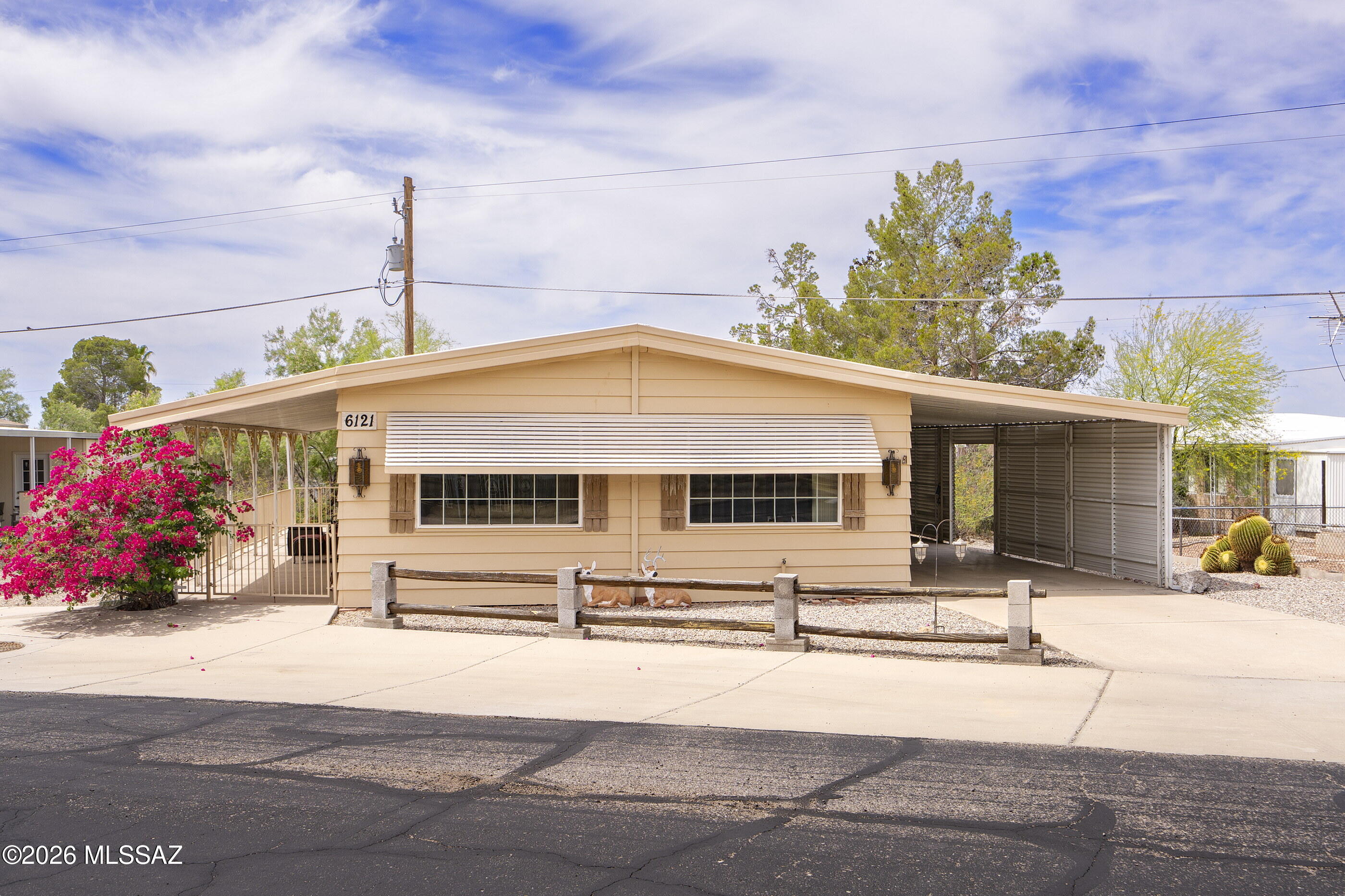 6121 West Flying M Street Tucson, AZ 85713 - Photo 21 of 25 a front view of a building with street