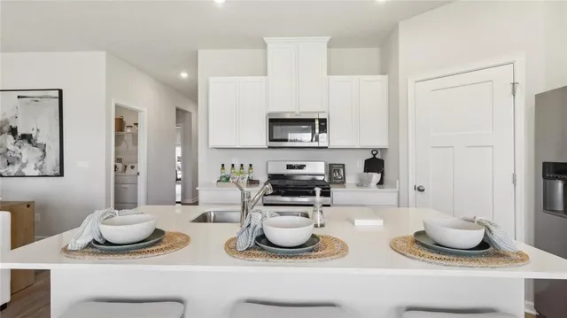 a kitchen with a sink and wooden cabinets