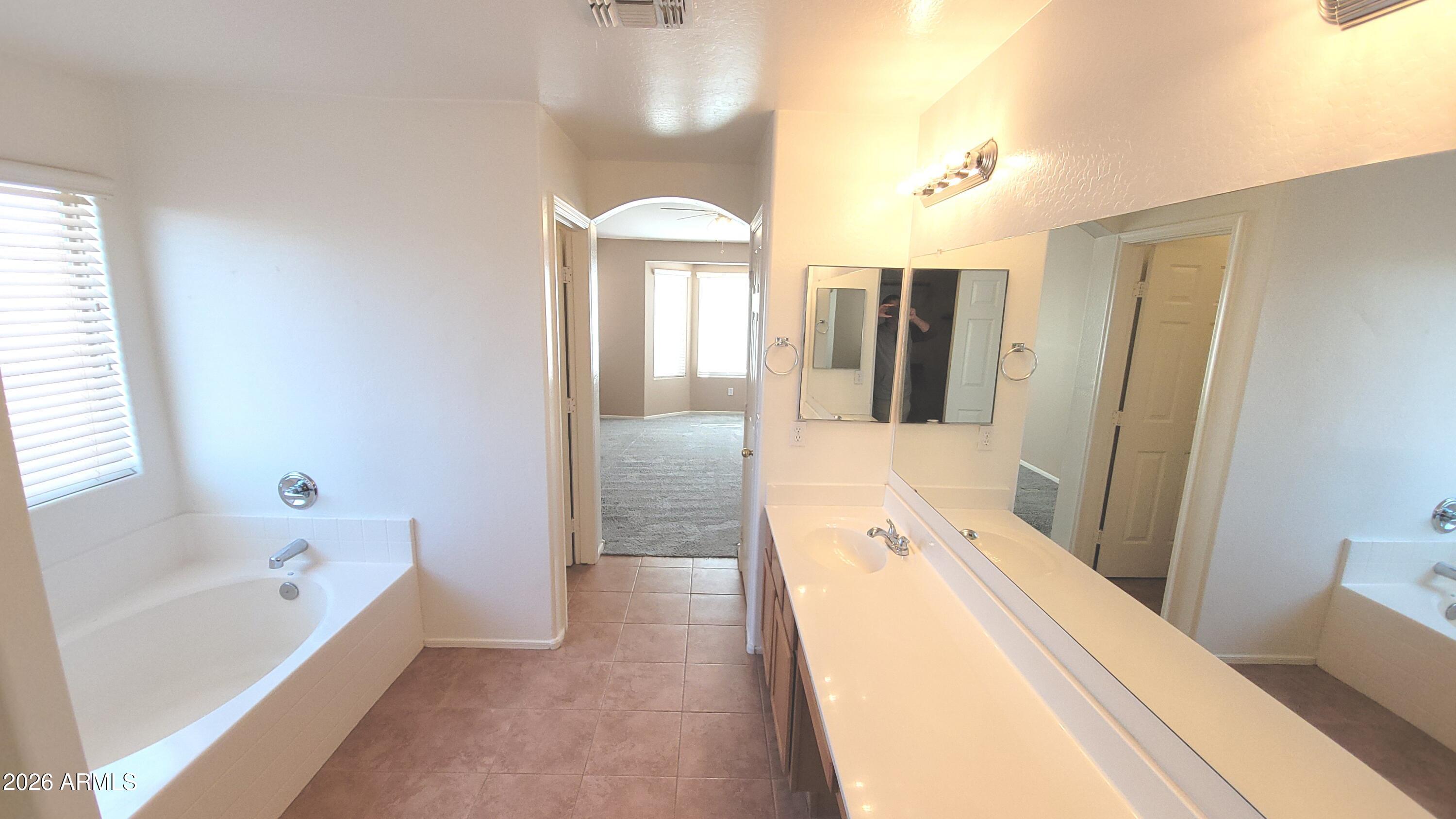 21821 East Via Del Rancho Queen Creek, AZ 85142 - Photo 17 of 35 a spacious bathroom with a tub and shower