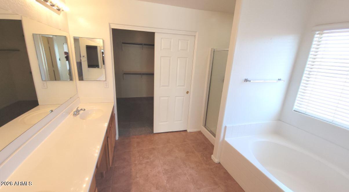21821 East Via Del Rancho Queen Creek, AZ 85142 - Photo 18 of 35 a bathroom with a tub and shower