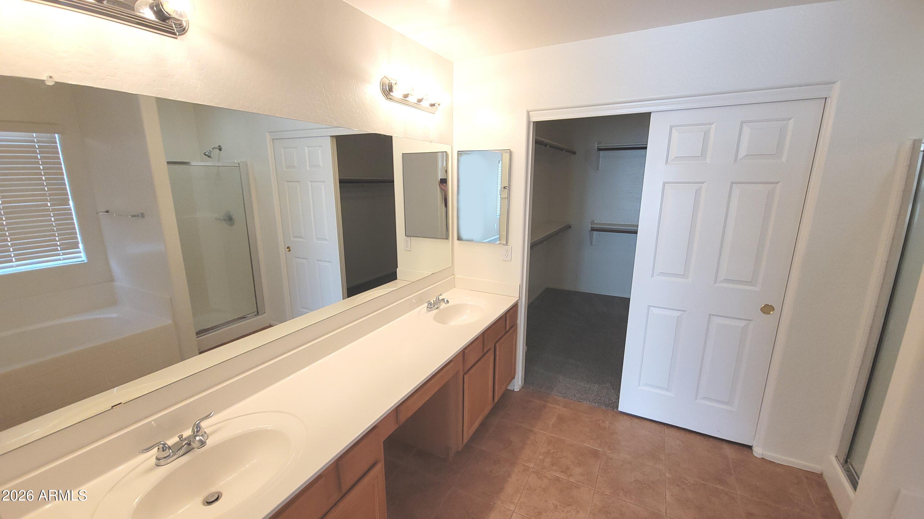 21821 East Via Del Rancho Queen Creek, AZ 85142 - Photo 19 of 35 a bathroom with a double vanity sink and a mirror