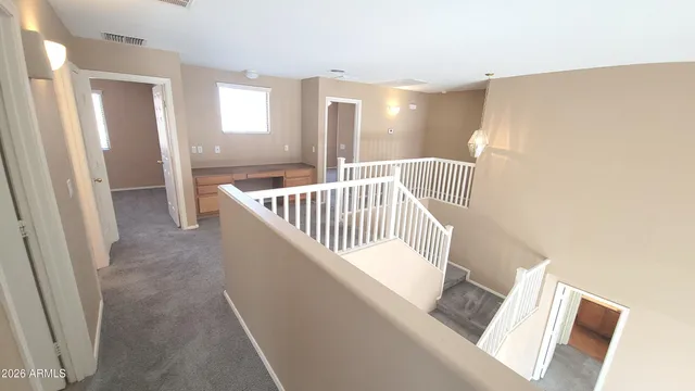 a view of staircase with white walls and windows