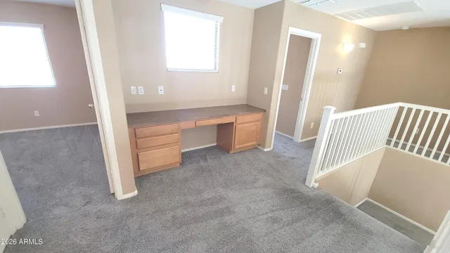 a kitchen with a refrigerator a stove top oven and white cabinets