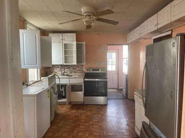 a kitchen with stainless steel appliances a stove a refrigerator and a sink