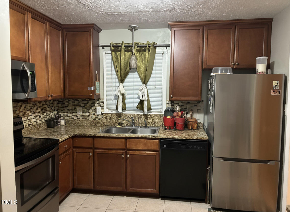 4642 Cheltenham Road Fayetteville, NC 28304 - Photo 5 of 29 L shaped kitchen. Window over sink has view of back yard.